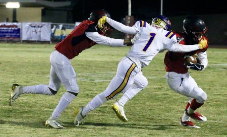 Lemoore's Aaron Villerreal avoids a block and keys on a Hanford player.